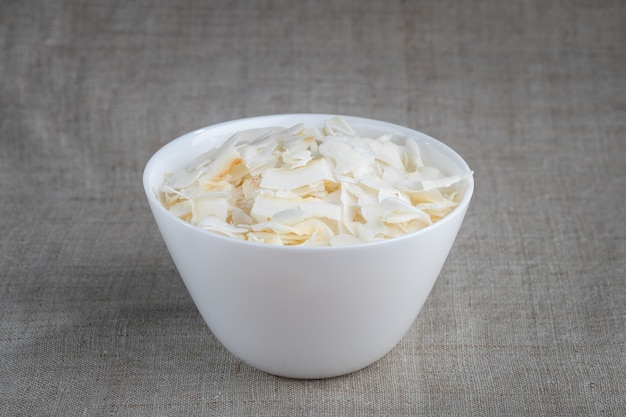 Coconut chips in a bowl on the table