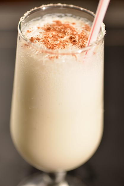 coconut cocktail with cinnamon and crystallized sugar