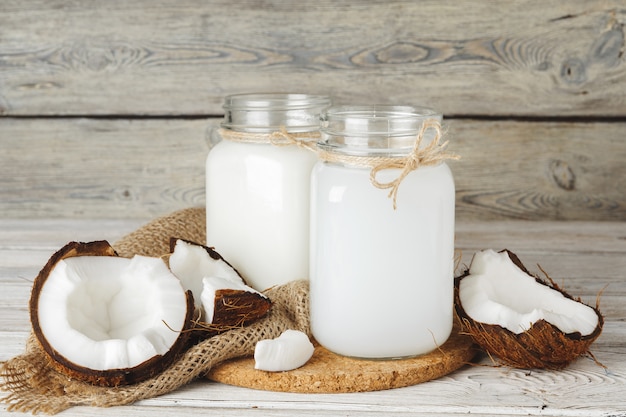 Coconut and coconut milk on rustic wooden table 