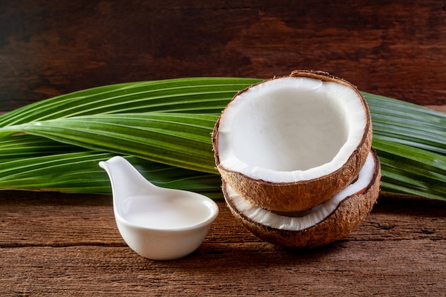 Coconut and coconut milk on wooden background.