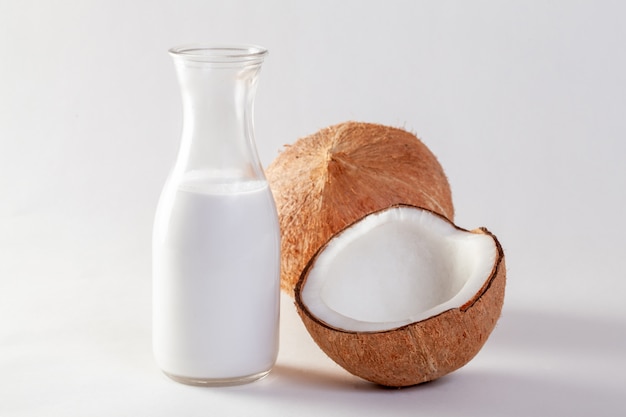 Coconut and coconut oil on white background.