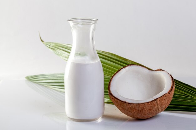 Coconut and coconut oil on white background.