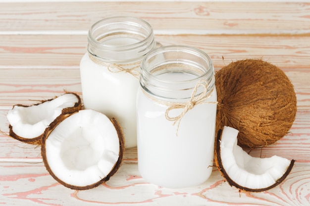 Coconut and  glass of coconut milk on  wooden background