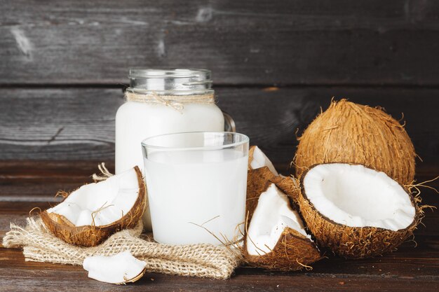 Coconut and glass jug with coconut milk