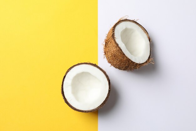 Coconut halves on two tone background, space for text