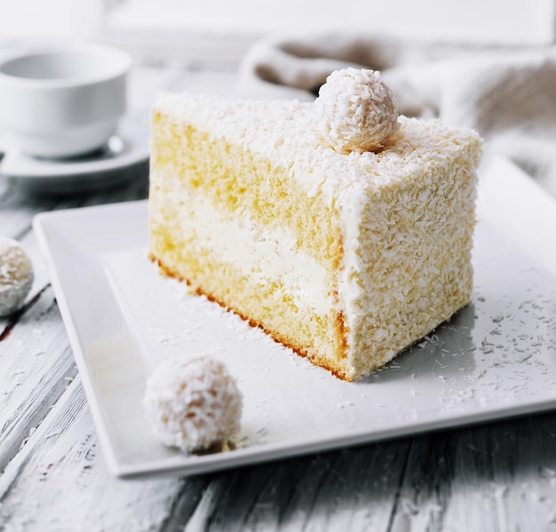 Coconut layered raffaello cake on white plate