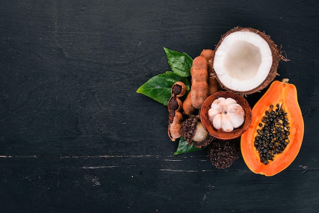 Coconut mangosteen papaya tamarind Fresh Tropical Fruits On a wooden background Top view Copy space