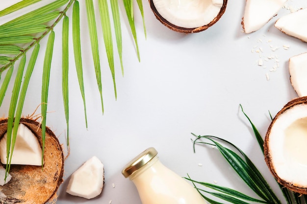 Coconut milk bottle fruit and peel on gray backgroundTop view hard light