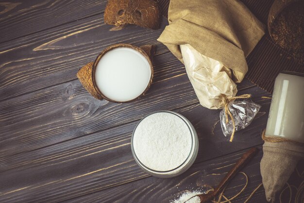 Coconut milk and fresh coconut flakes Glass bowl of coconut shavings Grated coconut in glass