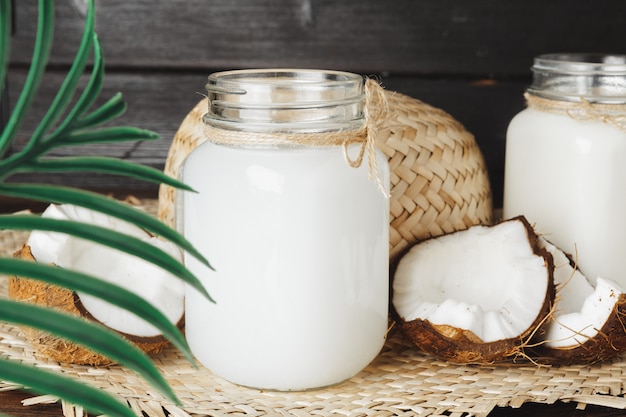 Coconut milk glass jar close up on wooden