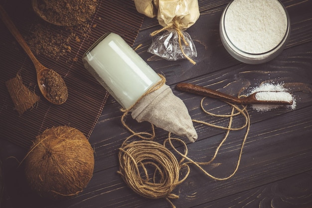 Coconut oil and coconuts Organic coconut products for spa Coconut oil in glass jar Coconut oil on table