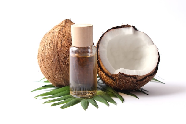 Coconut oil and coconuts, palm branches close up. High quality photo