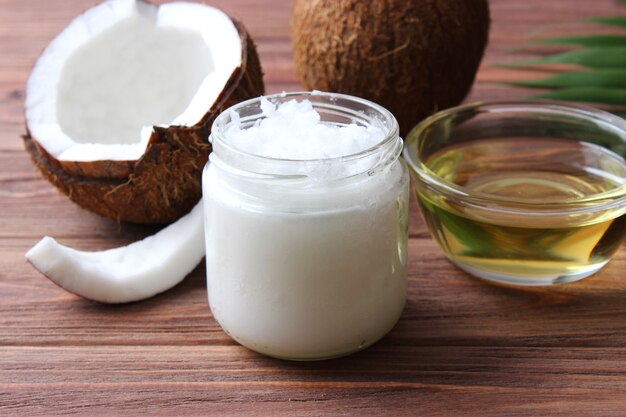 Coconut oil and coconuts palm branches close up