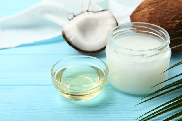 Coconut oil and coconuts on the table