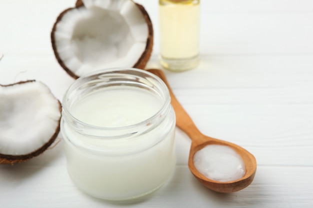 Coconut oil and coconuts on the table