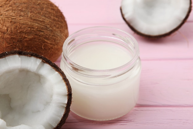 Coconut oil and coconuts on the table