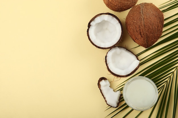 Coconut oil and coconuts on the table