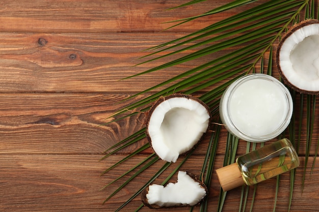 Coconut oil and coconuts on the table