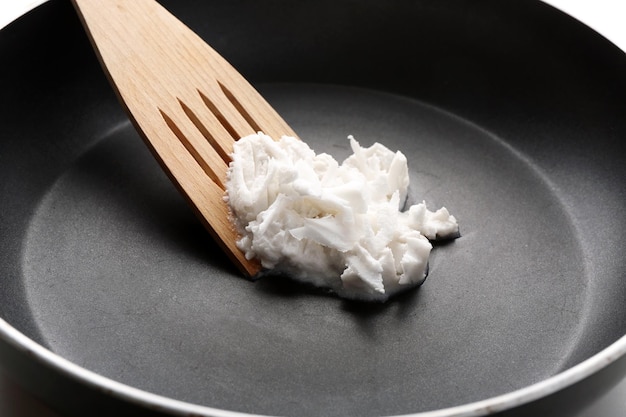 Coconut oil in frying pan close up