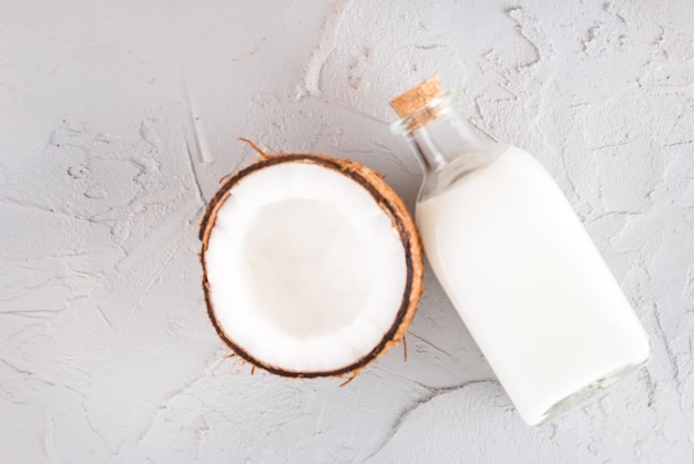 coconut oil in glass bottle with fresh nut