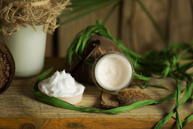 Coconut oil in glass jar and coconut cream Coconut oil on table