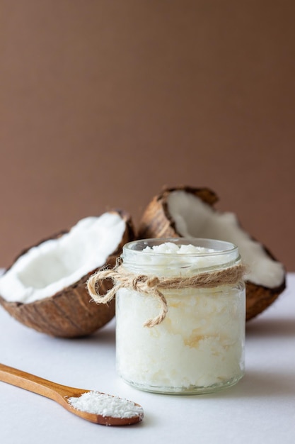 Coconut oil in a jar and fresh coconuts. Natural cosmetics.