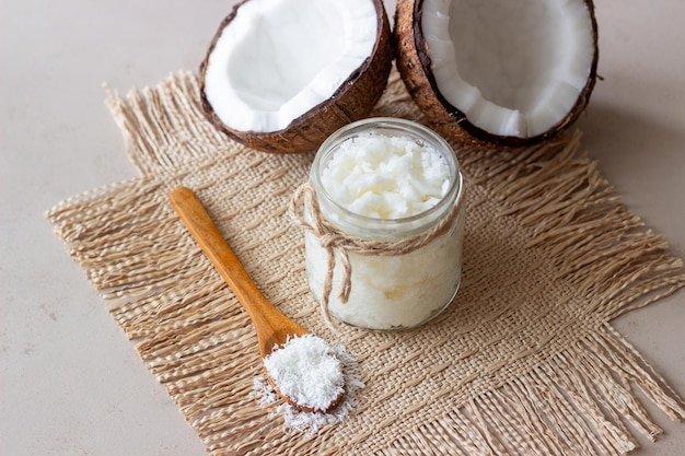 Coconut oil in a jar and fresh coconuts. Natural cosmetics.