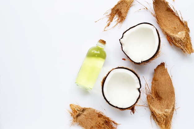 Coconut oil with coconuts on white 