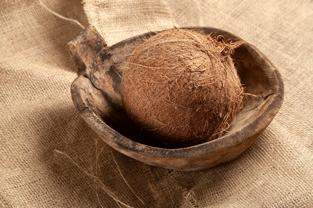 Coconut in old antique wooden plate