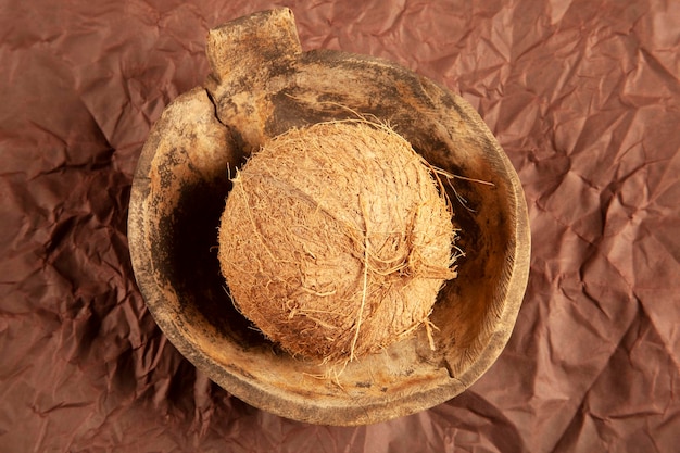 Coconut in old antique wooden plate