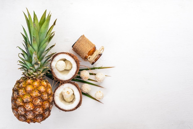 Coconut and pineapple on a wooden background Tropical fruits and nuts Top view Free space for text