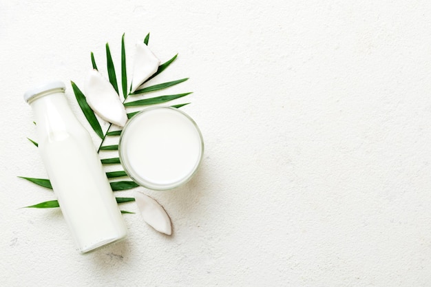 coconut products on white wooden table background Dairy free milk substitute drink Flat lay healthy eating