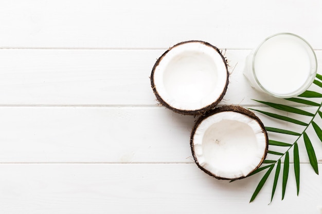 coconut products on white wooden table background dairy free milk substitute drink flat lay healthy eating