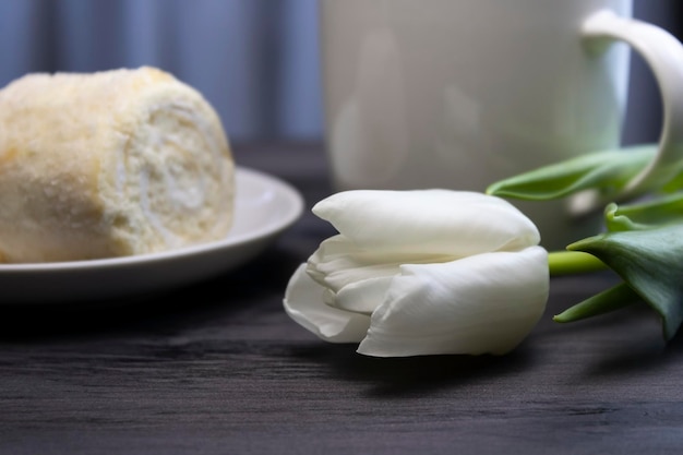 Coconut roll in a saucer and a flower closeup