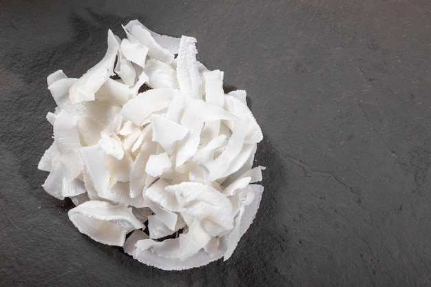 Coconut shavings on top of stone.