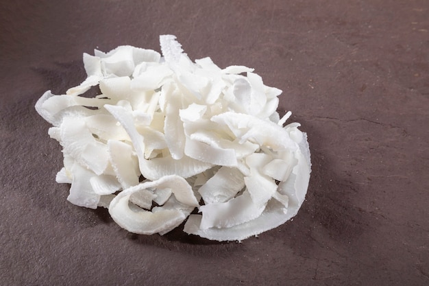 Coconut shavings on top of stone.