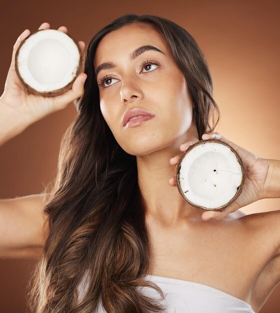 Coconut skincare beauty woman and studio for health wellness and natural radiant glow by backdrop Model face and fruit for nutrition cosmetics or coconut oil for skin moisturizer by background