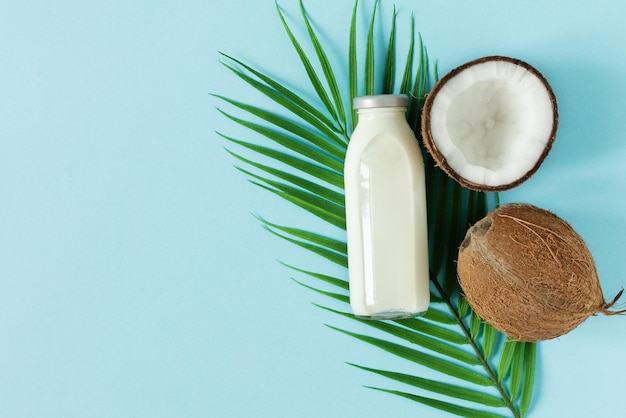 Coconut vegan milk top view on blue background