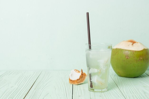 Acqua di cocco o succo di cocco in bicchiere con cubetto di ghiaccio