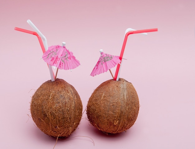 Coconut with drinking straw and umbrella