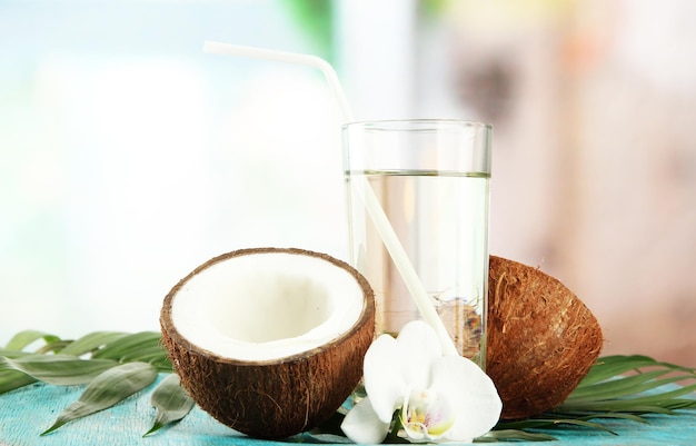 Coconut with glass of milk on blue wooden table