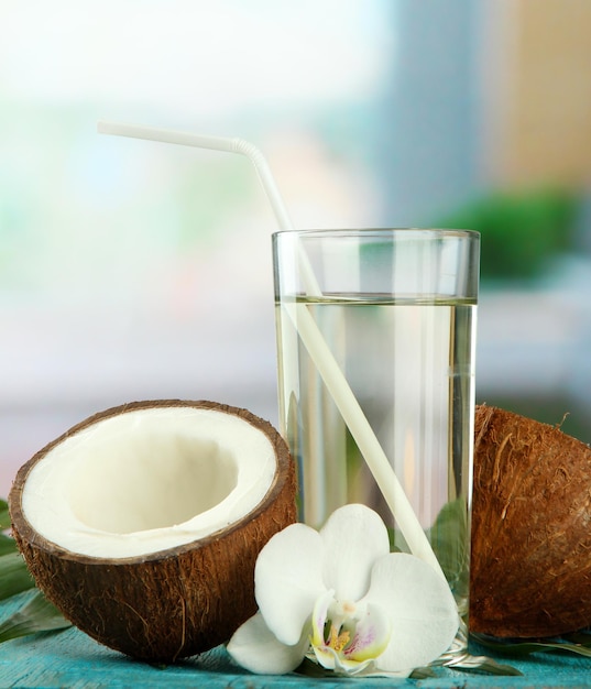 Coconut with glass of milk on blue wooden table