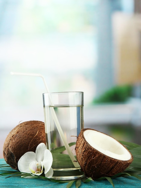 Coconut with glass of milk on blue wooden table