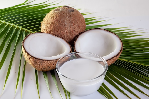 Coconut with milk  on coconut leaf background