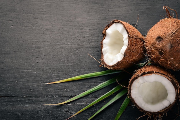 Coconut on a wooden background Tropical fruits and nuts Top view Free space for text