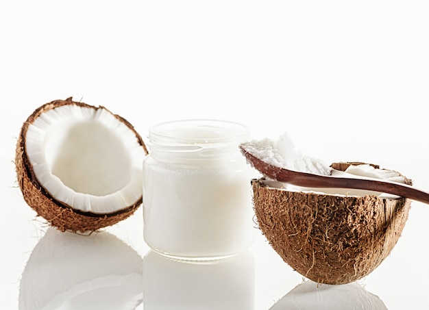 Coconut, wooden spoon and jar of coconut butter