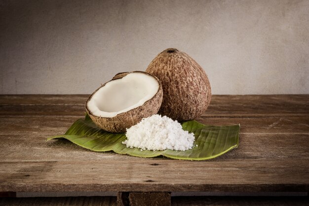 Coconuts and coconut flakes on banana leaf