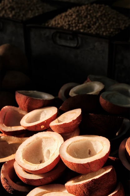 Coconuts in vegetable market in street lit by sun in india