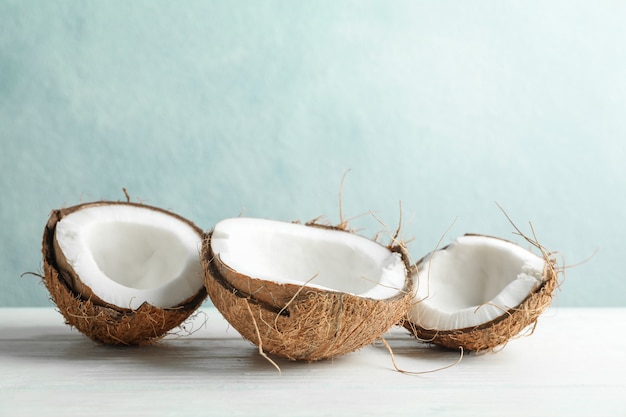 Coconuts on white wooden table against grey