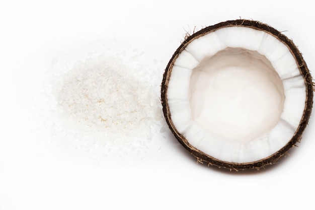 Coconuts with coconuts flakes isolated on the white background